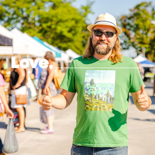 Man in a green shirt gives the thumbs up.